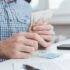Businessman calculates the costs incurred or salary